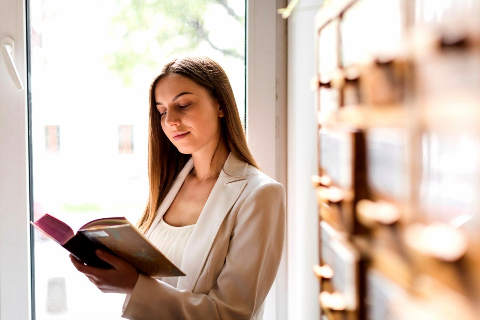 Person reviewing financial documents and planning budget with calculator and charts on desk
